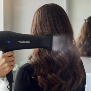 A slim concentrator nozzle attachment directing airflow downwards for a smooth, salon-style finish on thick hair.