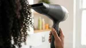 A wide-tooth comb attachment on a dryer, ideal for gently detangling and stretching textured hair.