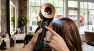 An illustration showing ionic technology smoothing the hair cuticle of coloured tresses to reduce frizz.