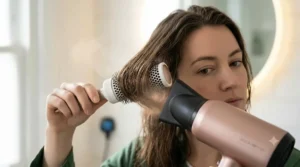 Focused airflow from a quick dry hair dryer using a concentrator nozzle to achieve a smooth, sleek finish during blow-drying.