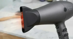 Hair dryer fitted with a diffuser attachment to enhance natural curls.
