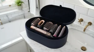 Complete 5 in 1 hair styler kit laid out in its presentation box with interchangeable curling barrels and drying attachments.