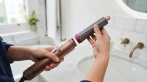 Close-up of hair wrapping automatically around the Coanda smoothing curling barrel of a 5 in 1 hair styler.
