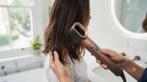 Pre-styling dryer nozzle attachment on a 5 in 1 hair styler damp-drying hair prior to curling.