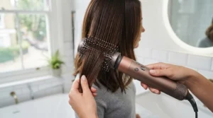 Using the firm smoothing brush attachment on a 5 in 1 hair styler for a sleek, frizz-free blow dry finish.