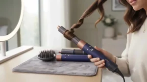 Close-up of hair wrapping automatically around the Dyson Airwrap barrel using Coanda airflow technology.