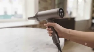 An ergonomic long cord hair dryer being held comfortably to demonstrate lightweight design.