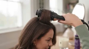 Demonstration of using the Revlon hot air brush to create volume at the hair roots.