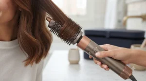 Oval volumising brush attachment on an all-in-one hair styling tool lifting fine hair from the root for a bouncy blow-dry finish.