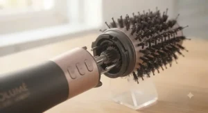 Extreme close-up of the precision engineering where the volumising brush head attaches to the handle, showing the internal connection gears.