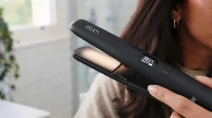 Digital temperature control display on a ceramic hair styling tool for precise heat management.