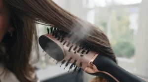 Streamlined styling process showing damp hair being simultaneously dried and styled into bouncy waves.