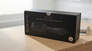 Flat paddle hot air brush unboxed alongside instruction manual and styling accessories for the UK market.