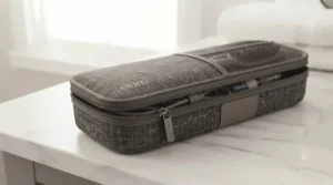 Ceramic hair straighteners resting safely on a heat-resistant silicone storage mat.