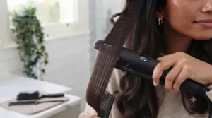 Sectioning thick hair cleanly before styling with professional ceramic straighteners.