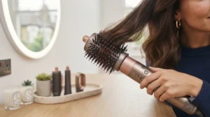 A round volumising brush attachment on a hair styler for adding lift and bounce at the roots.