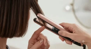 Close-up of slim ceramic floating plates on a mini hair straightener styling a pixie cut.
