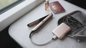 A wireless, USB-rechargeable mini travel straightener being charged with a power bank inside a handbag.