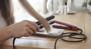 Full-size hair straighteners gliding through long, thick hair to achieve a sleek, frizz-free finish.