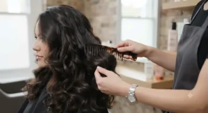 Finished hairstyle showing voluminous, glossy, and smooth waves achieved using curling tongs tailored for thick hair.