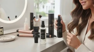 Applying professional heat protection spray before styling hair with curling tongs to prevent heat damage.