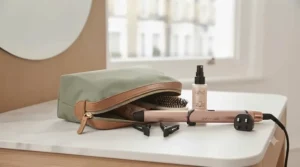 Compact travel curling wand and dual-voltage hair styling accessories packed inside a wash bag for weekend trips away in the UK.